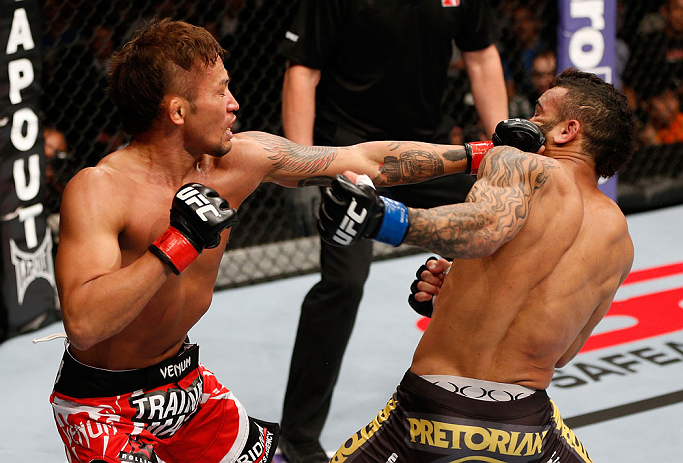 MACAU, MACAU - NOVEMBER 10:  (L-R) Yasuhiro Urushitani punches John Lineker during their flyweight bout at the UFC Macao event inside CotaiArena on November 10, 2012 in Macau, Macau.  (Photo by Josh Hedges/Zuffa LLC/Zuffa LLC via Getty Images)