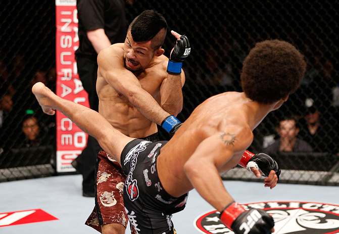 MACAU, MACAU - NOVEMBER 10:  (R-L) Alex Caceres kicks Motonobu Tezuka during their bantamweight bout at the UFC Macao event inside CotaiArena on November 10, 2012 in Macau, Macau.  (Photo by Josh Hedges/Zuffa LLC/Zuffa LLC via Getty Images)