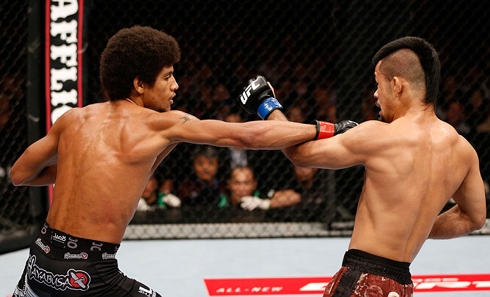MACAU, MACAU - NOVEMBER 10:  (L-R) Alex Caceres punches Motonobu Tezuka during their bantamweight bout at the UFC Macao event inside CotaiArena on November 10, 2012 in Macau, Macau.  (Photo by Josh Hedges/Zuffa LLC/Zuffa LLC via Getty Images)