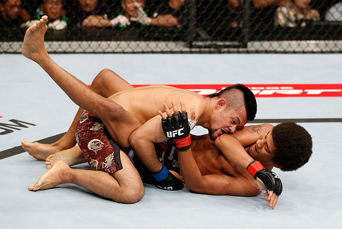 MACAU, MACAU - NOVEMBER 10:  (R-L) Alex Caceres delivers an elbow strike against Motonobu Tezuka during their bantamweight bout at the UFC Macao event inside CotaiArena on November 10, 2012 in Macau, Macau.  (Photo by Josh Hedges/Zuffa LLC/Zuffa LLC via Getty Images)