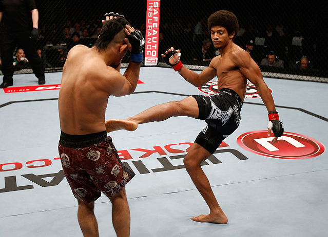MACAU, MACAU - NOVEMBER 10: (R-L) Alex Caceres kicks Motonobu Tezuka during their bantamweight bout at the UFC Macao event inside CotaiArena on November 10, 2012 in Macau, Macau. (Photo by Josh Hedges/Zuffa LLC/Zuffa LLC via Getty Images)