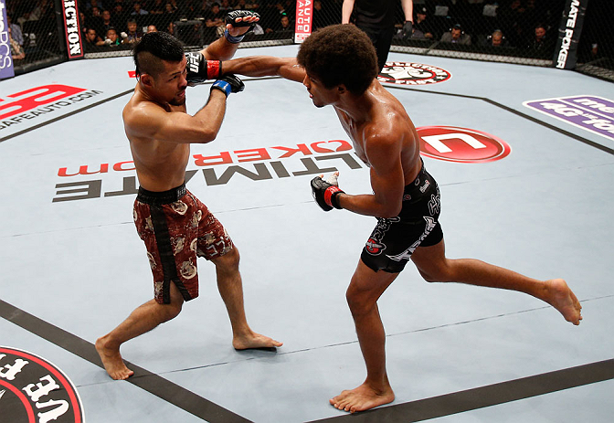 MACAU, MACAU - NOVEMBER 10: (R-L) Alex Caceres punches Motonobu Tezuka during their bantamweight bout at the UFC Macao event inside CotaiArena on November 10, 2012 in Macau, Macau. (Photo by Josh Hedges/Zuffa LLC/Zuffa LLC via Getty Images)