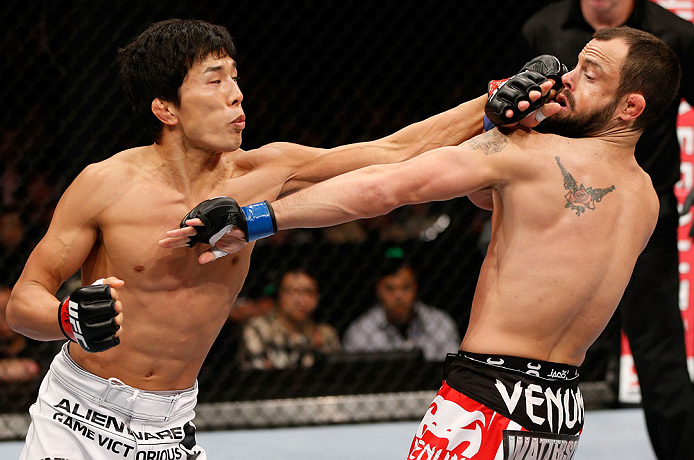 MACAU, MACAU - NOVEMBER 10:  (L-R) Takeya Mizugaki punches Jeff Hougland during their bantamweight bout at the UFC Macao event inside CotaiArena on November 10, 2012 in Macau, Macau.  (Photo by Josh Hedges/Zuffa LLC/Zuffa LLC via Getty Images)