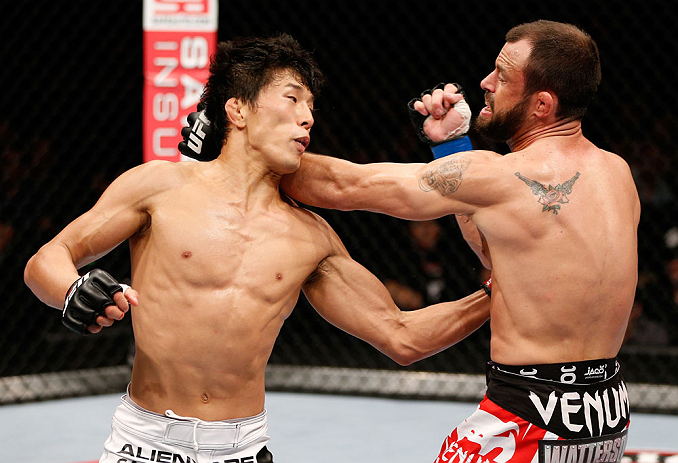 MACAU, MACAU - NOVEMBER 10:  (L-R) Takeya Mizugaki punches Jeff Hougland during their bantamweight bout at the UFC Macao event inside CotaiArena on November 10, 2012 in Macau, Macau.  (Photo by Josh Hedges/Zuffa LLC/Zuffa LLC via Getty Images)