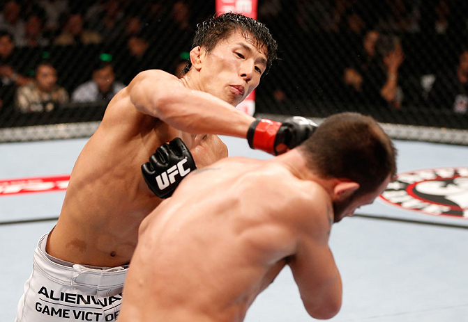 MACAU, MACAU - NOVEMBER 10:  (L-R) Takeya Mizugaki punches Jeff Hougland during their bantamweight bout at the UFC Macao event inside CotaiArena on November 10, 2012 in Macau, Macau.  (Photo by Josh Hedges/Zuffa LLC/Zuffa LLC via Getty Images)