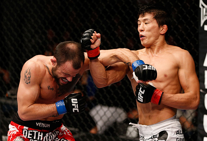 MACAU, MACAU - NOVEMBER 10:  (R-L) Takeya Mizugaki punches Jeff Hougland during their bantamweight bout at the UFC Macao event inside CotaiArena on November 10, 2012 in Macau, Macau.  (Photo by Josh Hedges/Zuffa LLC/Zuffa LLC via Getty Images)