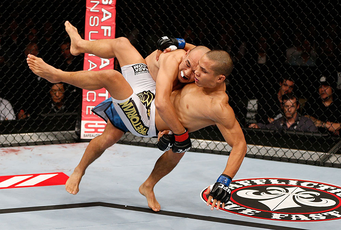 MACAU, MACAU - NOVEMBER 10: (L-R) Tiequan Zhang takes down Jon Tuck during their lightweight bout at the UFC Macao event inside CotaiArena on November 10, 2012 in Macau, Macau. (Photo by Josh Hedges/Zuffa LLC/Zuffa LLC via Getty Images)