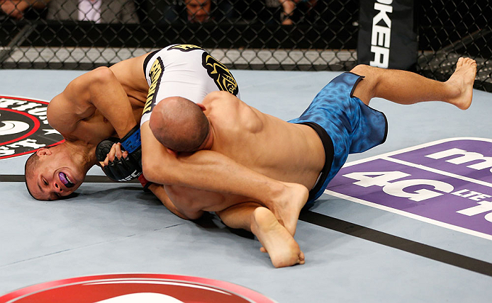 MACAU, MACAU - NOVEMBER 10: (L-R) Jon Tuck attempts an arm bar submission against Tiequan Zhang during their lightweight bout at the UFC Macao event inside CotaiArena on November 10, 2012 in Macau, Macau. (Photo by Josh Hedges/Zuffa LLC/Zuffa LLC via Getty Images)