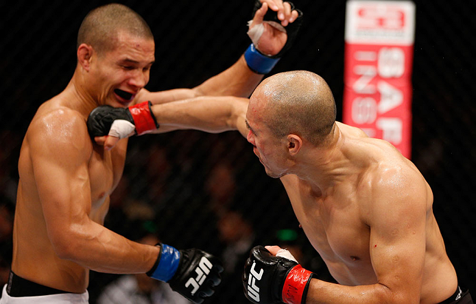 MACAU, MACAU - NOVEMBER 10: (R-L) Tiequan Zhang punches Jon Tuck during their lightweight bout at the UFC Macao event inside CotaiArena on November 10, 2012 in Macau, Macau. (Photo by Josh Hedges/Zuffa LLC/Zuffa LLC via Getty Images)
