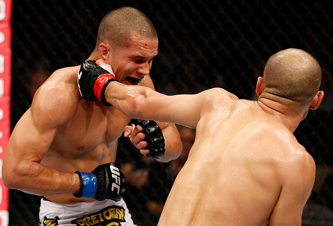 MACAU, MACAU - NOVEMBER 10: (R-L) Tiequan Zhang punches Jon Tuck during their lightweight bout at the UFC Macao event inside CotaiArena on November 10, 2012 in Macau, Macau. (Photo by Josh Hedges/Zuffa LLC/Zuffa LLC via Getty Images)