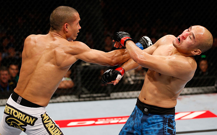 MACAU, MACAU - NOVEMBER 10: (L-R) Jon Tuck punches Tiequan Zhang during their lightweight bout at the UFC Macao event inside CotaiArena on November 10, 2012 in Macau, Macau. (Photo by Josh Hedges/Zuffa LLC/Zuffa LLC via Getty Images)