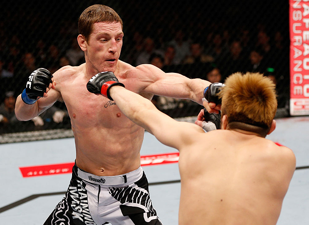 MACAU, MACAU - NOVEMBER 10: (L-R) Mac Danzig punches Takanori Gomi during their lightweight bout at the UFC Macao event inside CotaiArena on November 10, 2012 in Macau, Macau. (Photo by Josh Hedges/Zuffa LLC/Zuffa LLC via Getty Images)