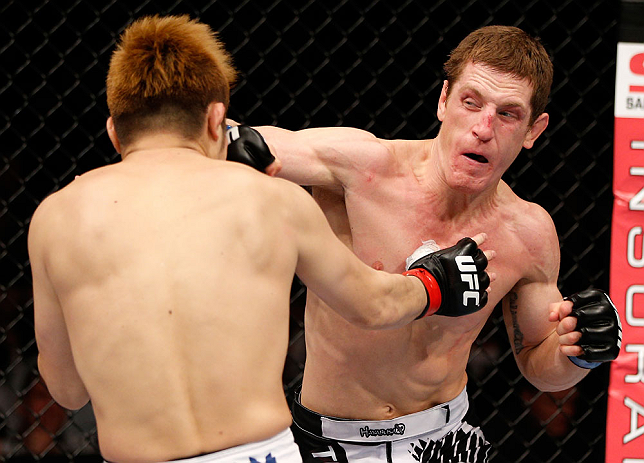 MACAU, MACAU - NOVEMBER 10: (R-L) Mac Danzig punches Takanori Gomi during their lightweight bout at the UFC Macao event inside CotaiArena on November 10, 2012 in Macau, Macau. (Photo by Josh Hedges/Zuffa LLC/Zuffa LLC via Getty Images)
