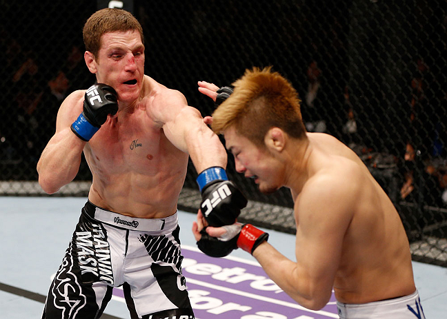 MACAU, MACAU - NOVEMBER 10: (L-R) Mac Danzig punches Takanori Gomi during their lightweight bout at the UFC Macao event inside CotaiArena on November 10, 2012 in Macau, Macau. (Photo by Josh Hedges/Zuffa LLC/Zuffa LLC via Getty Images)
