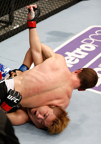 MACAU, MACAU - NOVEMBER 10: (R-L) Mac Danzig attempts a guillotine choke against Takanori Gomi during their lightweight bout at the UFC Macao event inside CotaiArena on November 10, 2012 in Macau, Macau. (Photo by Josh Hedges/Zuffa LLC/Zuffa LLC via Getty Images)