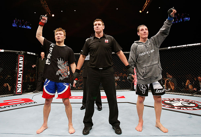MACAU, MACAU - NOVEMBER 10: Takanori Gomi (L) and Mac Danzig (R) react as the judges' scores are read after their lightweight bout at the UFC Macao event inside CotaiArena on November 10, 2012 in Macau, Macau. (Photo by Josh Hedges/Zuffa LLC/Zuffa LLC via Getty Images)