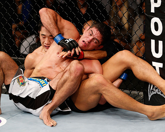 MACAU, MACAU - NOVEMBER 10: (R-L) Paulo Thiago and Dong Hyun Kim grapple for position during their welterweight bout at the UFC Macao event inside CotaiArena on November 10, 2012 in Macau, Macau. (Photo by Josh Hedges/Zuffa LLC/Zuffa LLC via Getty Images)