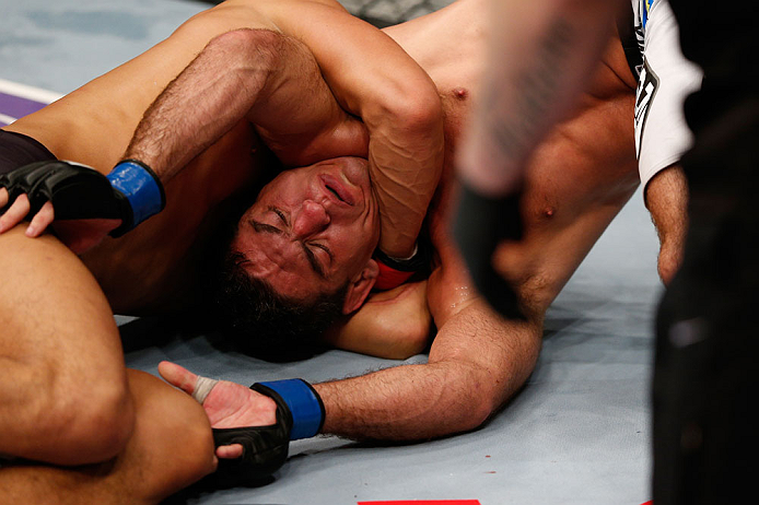 MACAU, MACAU - NOVEMBER 10: (R-L) Paulo Thiago fights off a choke attempt by Dong Hyun Kim during their welterweight bout at the UFC Macao event inside CotaiArena on November 10, 2012 in Macau, Macau. (Photo by Josh Hedges/Zuffa LLC/Zuffa LLC via Getty Images)