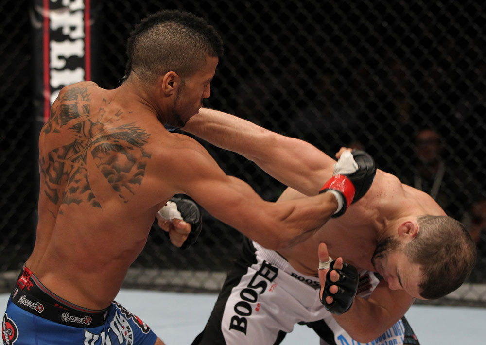 STOCKHOLM, SWEDEN - APRIL 14: (L-R) Jason Young punches Eric Wisely during their featherweight bout at the UFC on Fuel TV event at Ericsson Globe on April 14, 2012 in Stockholm, Sweden. (Photo by Josh Hedges/Zuffa LLC/Zuffa LLC via Getty Images)