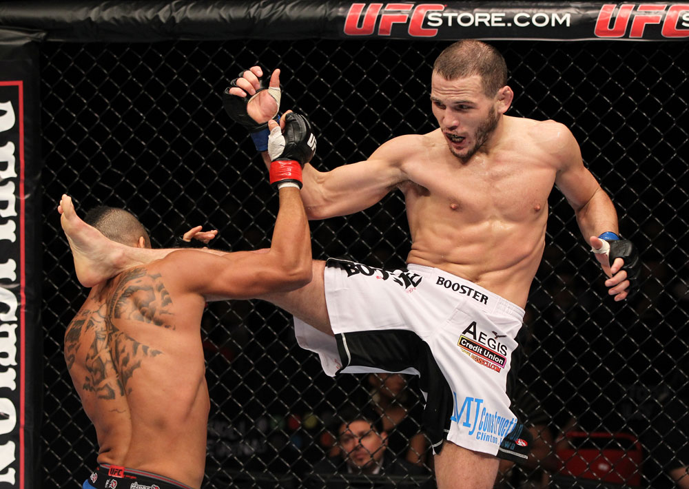 STOCKHOLM, SWEDEN - APRIL 14: (R-L) Eric Wisely kicks Jason Young during their featherweight bout at the UFC on Fuel TV event at Ericsson Globe on April 14, 2012 in Stockholm, Sweden. (Photo by Josh Hedges/Zuffa LLC/Zuffa LLC via Getty Images)