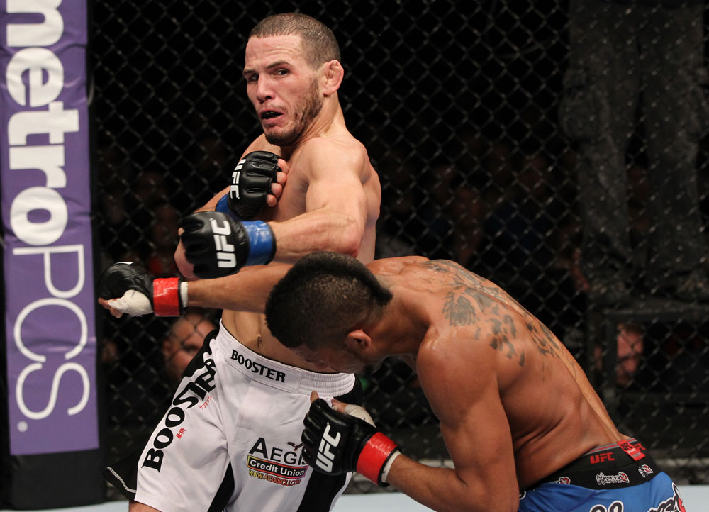 STOCKHOLM, SWEDEN - APRIL 14: (L-R) Eric Wisely trades punches with Jason Young during their featherweight bout at the UFC on Fuel TV event at Ericsson Globe on April 14, 2012 in Stockholm, Sweden. (Photo by Josh Hedges/Zuffa LLC/Zuffa LLC via Getty Images)