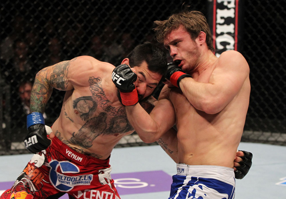 STOCKHOLM, SWEDEN - APRIL 14: (R-L) Brad Pickett punches Damacio Page during their bantamweight bout at the UFC on Fuel TV event at Ericsson Globe on April 14, 2012 in Stockholm, Sweden. (Photo by Josh Hedges/Zuffa LLC/Zuffa LLC via Getty Images)