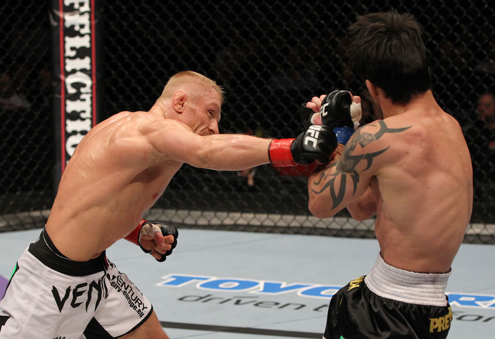 STOCKHOLM, SWEDEN - APRIL 14: (L-R) Dennis Siver punches Diego Nunes during their featherweight bout at the UFC on Fuel TV event at Ericsson Globe on April 14, 2012 in Stockholm, Sweden. (Photo by Josh Hedges/Zuffa LLC/Zuffa LLC via Getty Images)