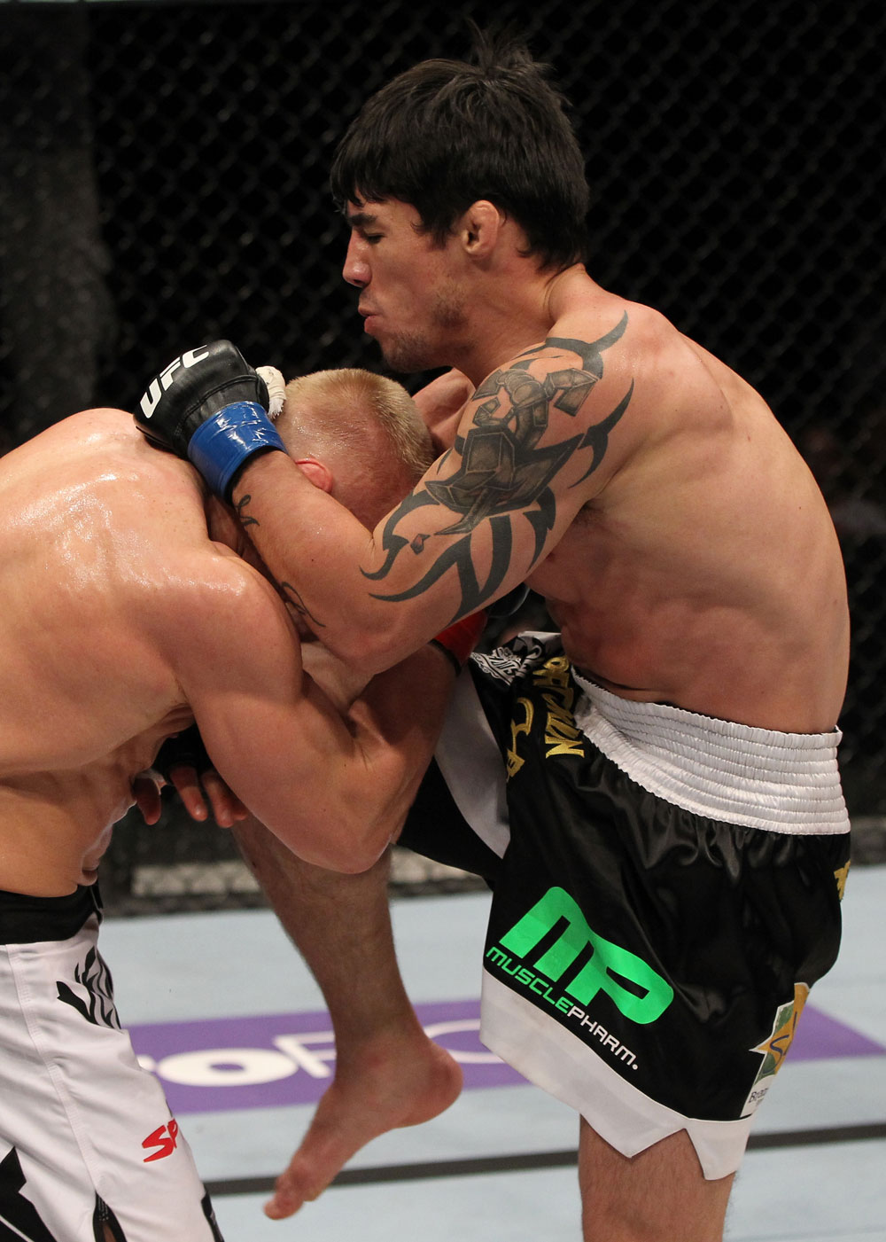 STOCKHOLM, SWEDEN - APRIL 14: (R-L) Diego Nunes delivers a knee strike against Dennis Siver during their featherweight bout at the UFC on Fuel TV event at Ericsson Globe on April 14, 2012 in Stockholm, Sweden. (Photo by Josh Hedges/Zuffa LLC/Zuffa LLC via Getty Images)