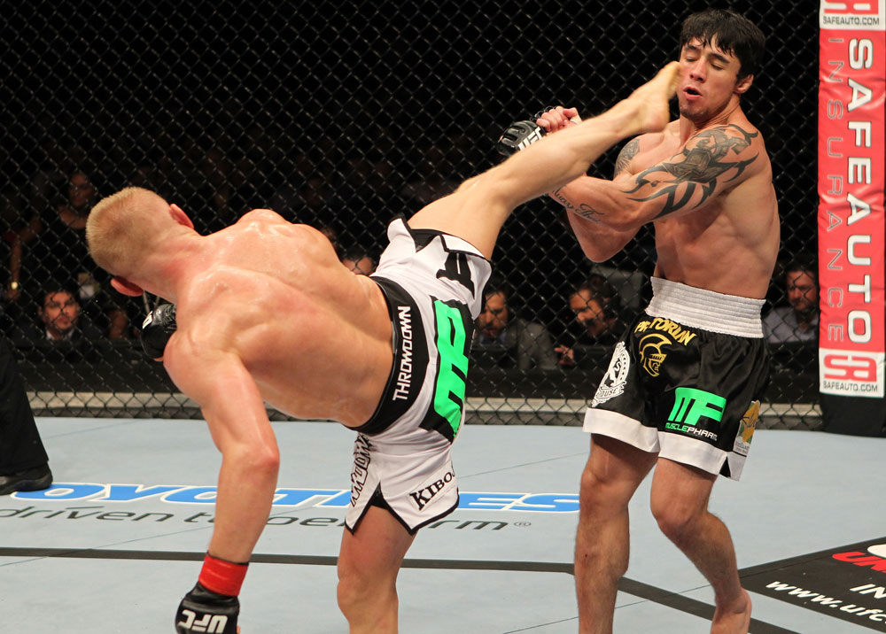 STOCKHOLM, SWEDEN - APRIL 14: (L-R) Dennis Siver kicks Diego Nunes during their featherweight bout at the UFC on Fuel TV event at Ericsson Globe on April 14, 2012 in Stockholm, Sweden. (Photo by Josh Hedges/Zuffa LLC/Zuffa LLC via Getty Images)