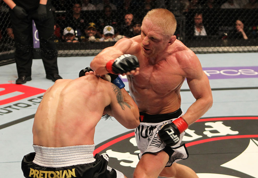 STOCKHOLM, SWEDEN - APRIL 14: (R-L) Dennis Siver punches Diego Nunes during their featherweight bout at the UFC on Fuel TV event at Ericsson Globe on April 14, 2012 in Stockholm, Sweden. (Photo by Josh Hedges/Zuffa LLC/Zuffa LLC via Getty Images)