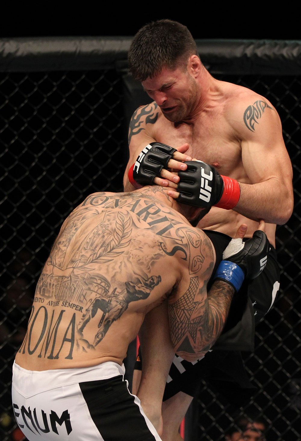 STOCKHOLM, SWEDEN - APRIL 14: (R-L) Brian Stann delivers a knee strike against Alessio Sakara during their middleweight bout at the UFC on Fuel TV event at Ericsson Globe on April 14, 2012 in Stockholm, Sweden. (Photo by Josh Hedges/Zuffa LLC/Zuffa LLC via Getty Images)