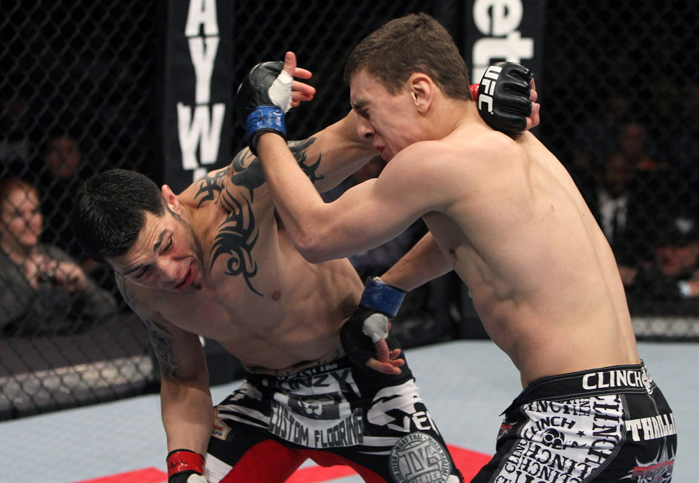 NASHVILLE, TN - JANUARY 20:  (L-R) Daniel Pineda punches Pat Schilling during the UFC on FX event at Bridgestone Arena on January 20, 2012 in Nashville, Tennessee.  (Photo by Josh Hedges/Zuffa LLC/Zuffa LLC via Getty Images)