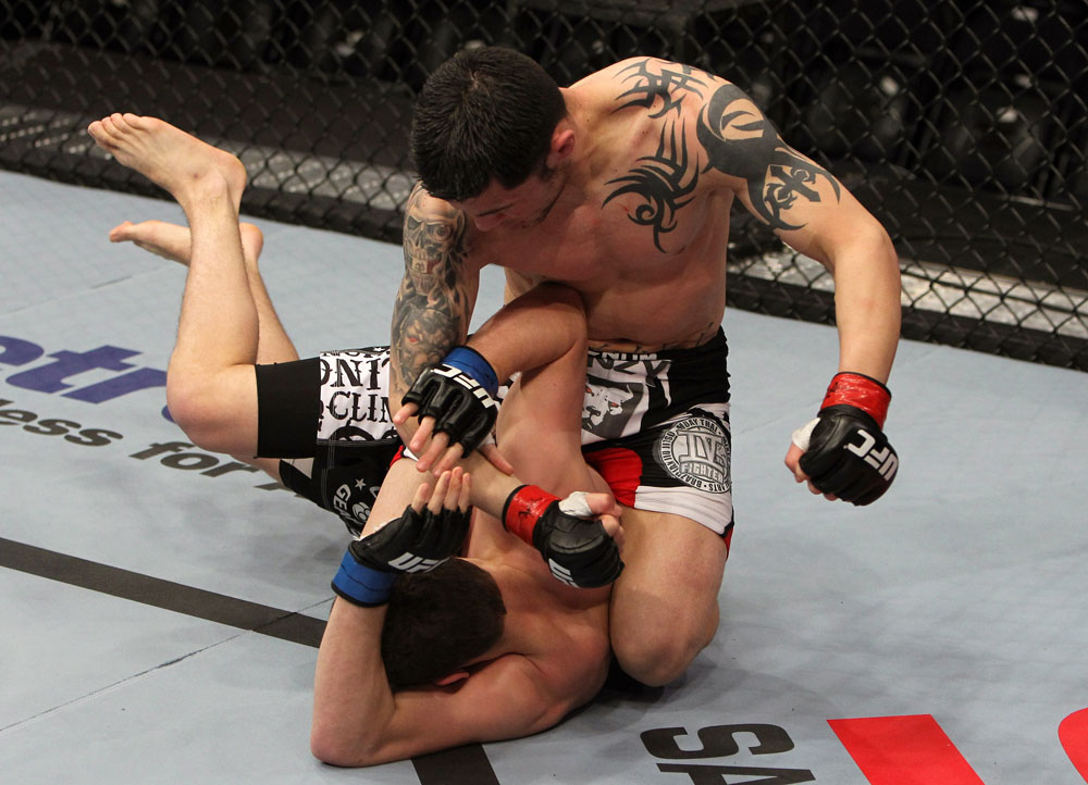 NASHVILLE, TN - JANUARY 20:  (R-L) Daniel Pineda punches Pat Schilling during the UFC on FX event at Bridgestone Arena on January 20, 2012 in Nashville, Tennessee.  (Photo by Josh Hedges/Zuffa LLC/Zuffa LLC via Getty Images)