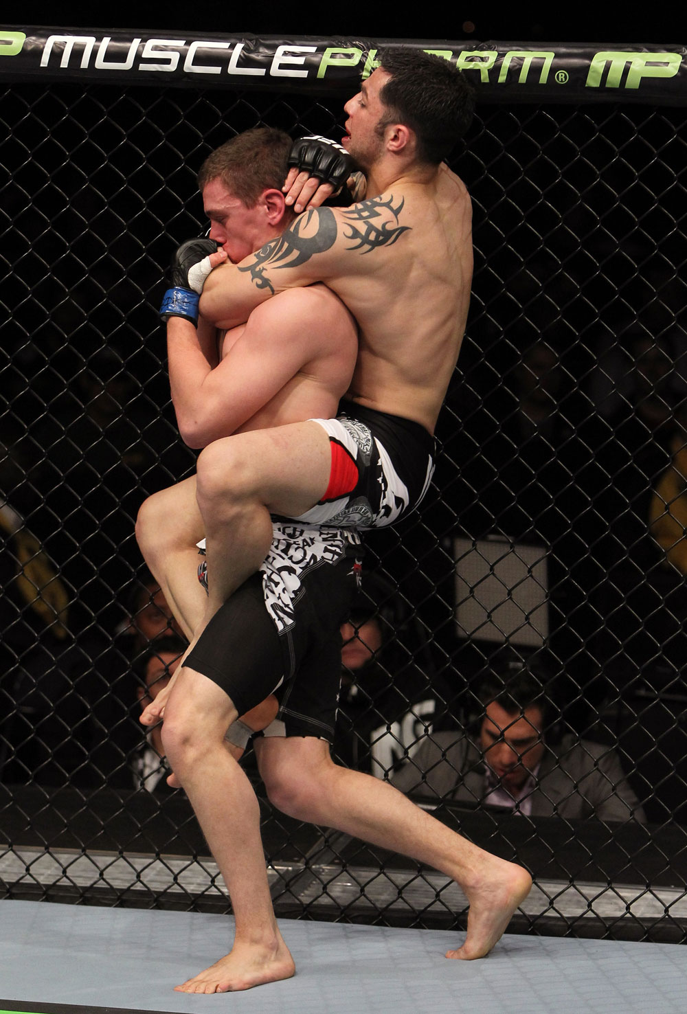 NASHVILLE, TN - JANUARY 20:  (R-L) Daniel Pineda secures a rear choke submission to defeat Pat Schilling during the UFC on FX event at Bridgestone Arena on January 20, 2012 in Nashville, Tennessee.  (Photo by Josh Hedges/Zuffa LLC/Zuffa LLC via Getty Images)