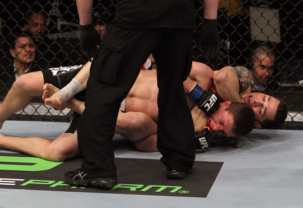NASHVILLE, TN - JANUARY 20:  (R-L) Daniel Pineda secures a rear choke submission to defeat Pat Schilling during the UFC on FX event at Bridgestone Arena on January 20, 2012 in Nashville, Tennessee.  (Photo by Josh Hedges/Zuffa LLC/Zuffa LLC via Getty Images)