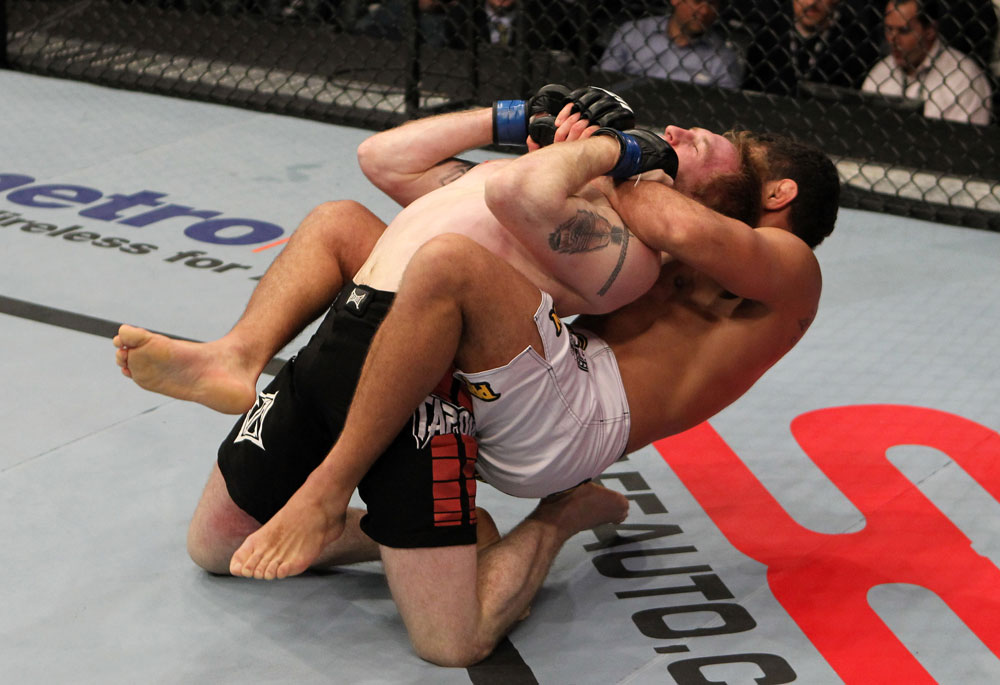 NASHVILLE, TN - JANUARY 20:  (R-L) Fabricio Camoes secures a rear choke submission against Tommy Hayden during the UFC on FX event at Bridgestone Arena on January 20, 2012 in Nashville, Tennessee.  (Photo by Josh Hedges/Zuffa LLC/Zuffa LLC via Getty Images)
