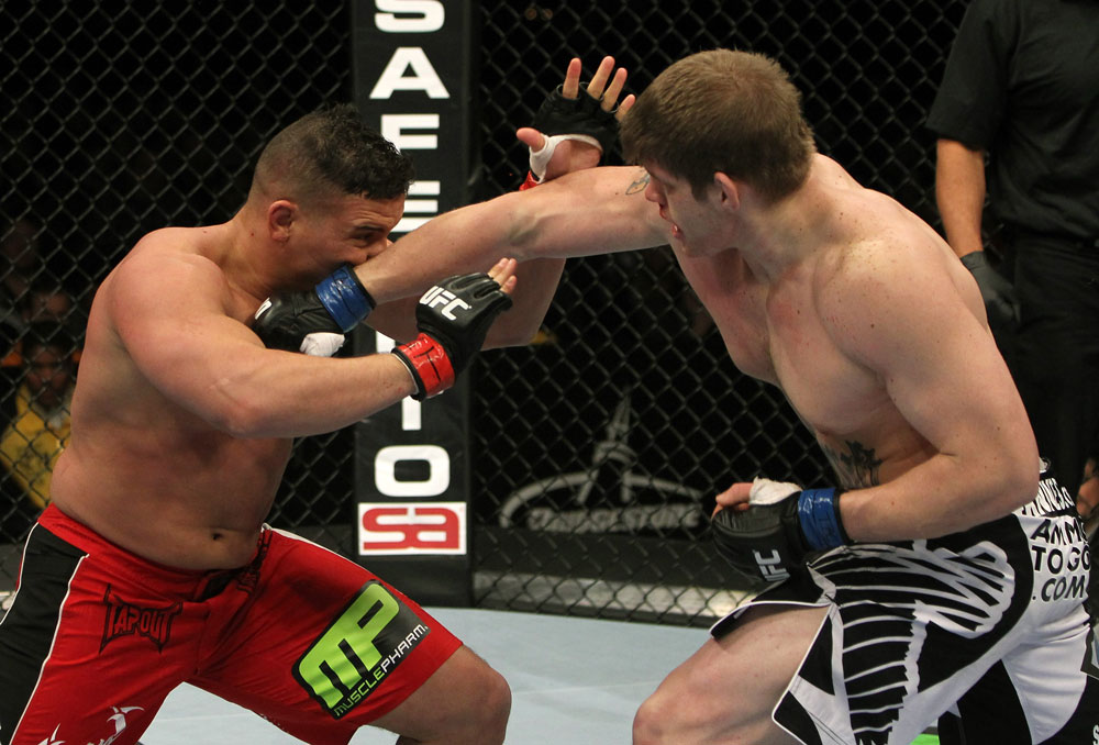 NASHVILLE, TN - JANUARY 20:  (R-L) Christian Morecraft punches Pat Barry during the UFC on FX event at Bridgestone Arena on January 20, 2012 in Nashville, Tennessee.  (Photo by Josh Hedges/Zuffa LLC/Zuffa LLC via Getty Images)