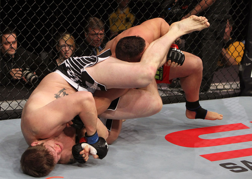 NASHVILLE, TN - JANUARY 20:  (L-R) Christian Morecraft attempts an arm bar submission against Pat Barry during the UFC on FX event at Bridgestone Arena on January 20, 2012 in Nashville, Tennessee.  (Photo by Josh Hedges/Zuffa LLC/Zuffa LLC via Getty Images)