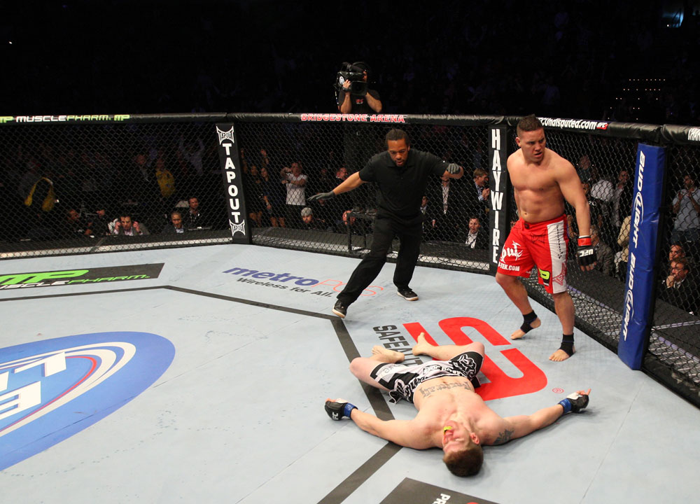 NASHVILLE, TN - JANUARY 20:  Pat Barry (red shorts) reacts after knocking out Christian Morecraft during the UFC on FX event at Bridgestone Arena on January 20, 2012 in Nashville, Tennessee.  (Photo by Josh Hedges/Zuffa LLC/Zuffa LLC via Getty Images)
