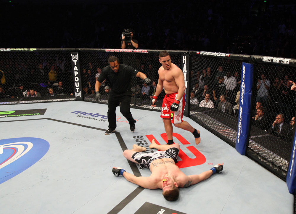 NASHVILLE, TN - JANUARY 20:  Pat Barry (red shorts) reacts after knocking out Christian Morecraft during the UFC on FX event at Bridgestone Arena on January 20, 2012 in Nashville, Tennessee.  (Photo by Josh Hedges/Zuffa LLC/Zuffa LLC via Getty Images)