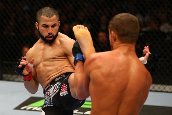Makdessi throws a front kick at Cruickshank Makdessi throws a front kick at Cruickshank