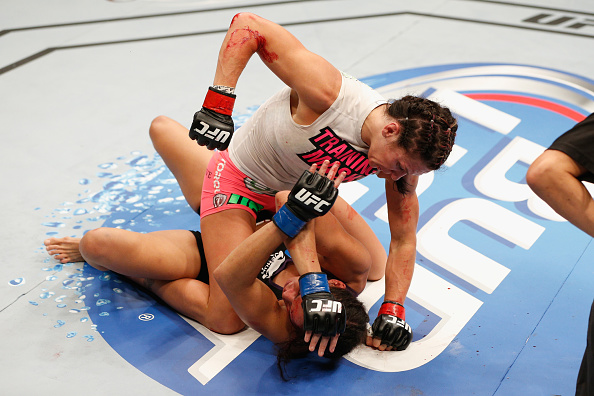 LAS VEGAS, NV - SEPT. 27: (Top) Cat Zingano punches Amanda Nunes in their women's bantamweight fight during the UFC 178 event inside the MGM Grand Garden Arena. (Photo by Josh Hedges/Zuffa LLC)