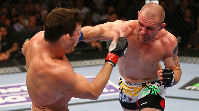 Alan Belcher (R) punches Michael Bisping (L) of England in thier middleweight bout during the UFC 159 event at the Prudential Center on April 27, 2013 in Newark, New Jersey. (Photo by Al Bello/Zuffa LLC)