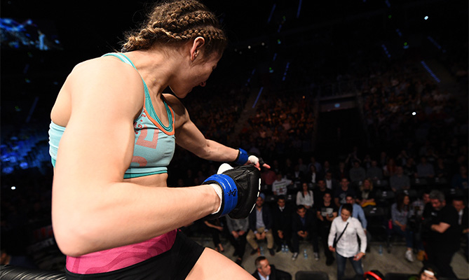 (L-R) Maryna Moroz of Croatia has words for UFC Women's Strawweight Champion Joanna Jedrzejczyk in the crowd after her victory over Joanne Calderwood of Scotland in their women's strawweight fight during the UFC Fight Night event at the Tauron Arena on April 11, 2015 in Krakow, Poland. (Photo by Jeff Bottari/Zuffa LLC)