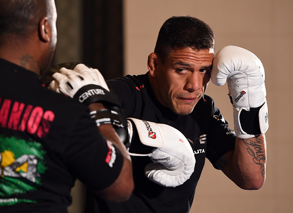 dos Anjos hitting mitts at Open Workouts