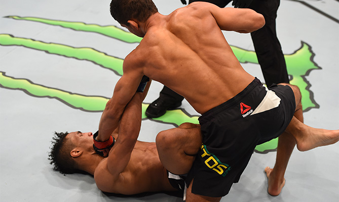 (R-L) Leonardo Santos of Brazil punches Kevin Lee in their lightweight bout during the UFC 194 event inside MGM Grand Garden Arena on December 12, 2015 in Las Vegas, Nevada. (Photo by Josh Hedges/Zuffa LLC)
