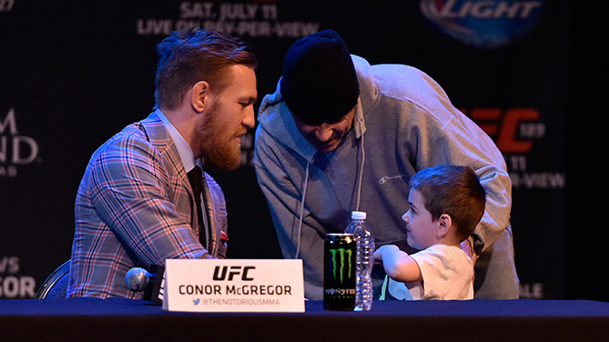 McGregor signs an autograph for a young fan