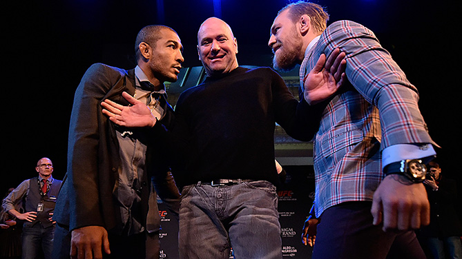Aldo (left) is separated by Dana White (middle) from McGregor