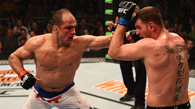 Dos Santos (left) throws left at Miocic