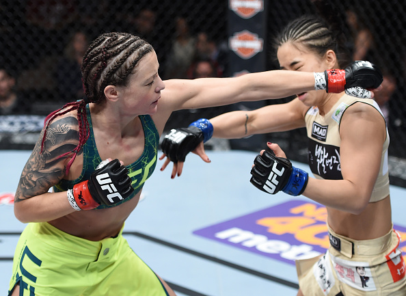 LAS VEGAS, NEVADA - DECEMBER 12: (L-R) Joanne Calderwood punches Seohee Ham in their strawweight fight during The Ultimate Fighter Finale event inside the Palms Casino Resort on December 12, 2014 in Las Vegas, Nevada. (Photo by Jeff Bottari/Zuffa LLC/Zuffa LLC via Getty Images)
